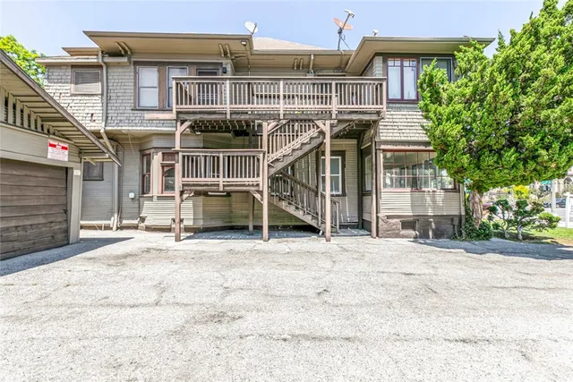 a view of a balcony with wooden floor and fence