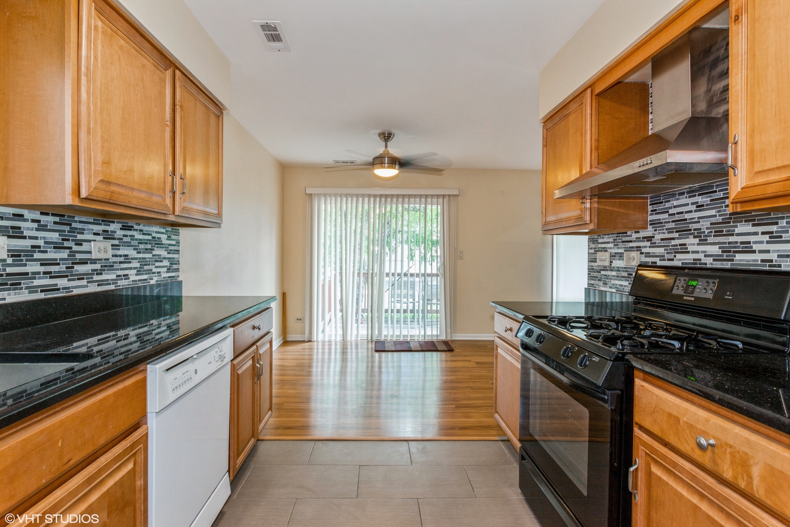 462 Old Surrey Road Hinsdale, IL 60521 - Photo 7 of 13 a kitchen with stainless steel appliances granite countertop a stove a sink and a microwave
