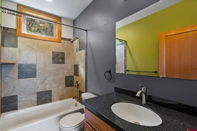 a bathroom with a sink toilet a mirror and shower