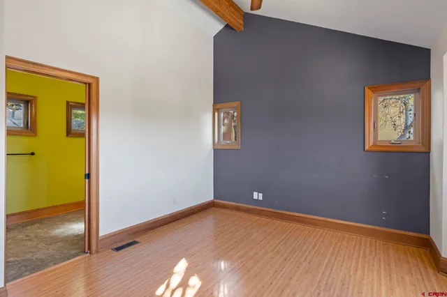 a view of room with window and wooden floor