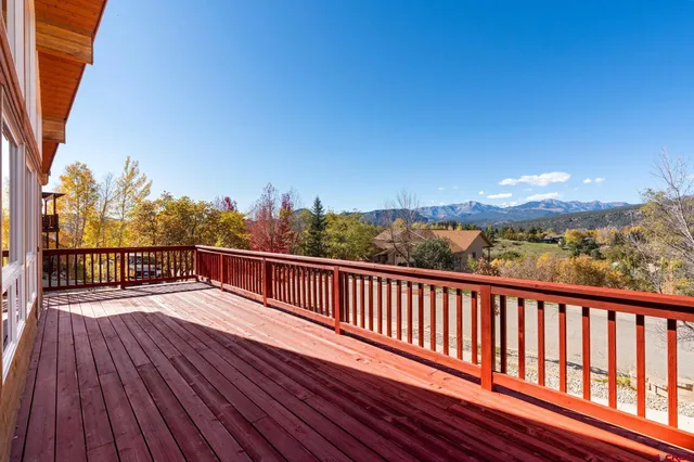 a view of balcony with wooden floor and fence