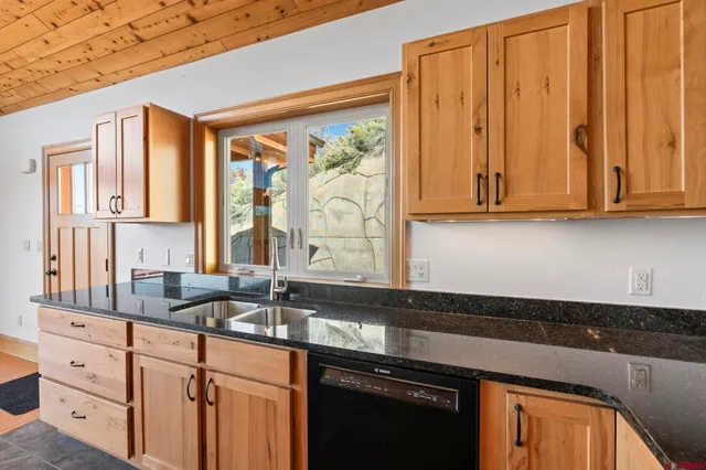 a kitchen with stainless steel appliances granite countertop a sink a stove and a microwave