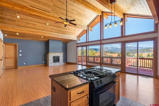 a kitchen with a stove and wooden floor