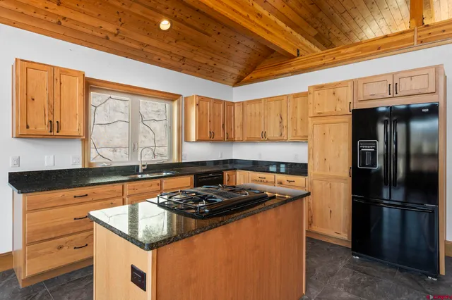 a kitchen with a stove a sink and a refrigerator