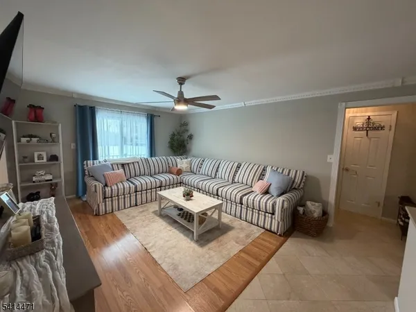 a living room with furniture and a chandelier