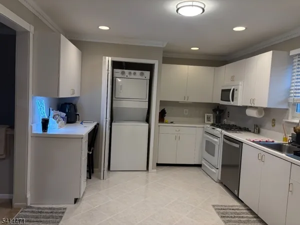 a kitchen with a sink cabinets and stainless steel appliances