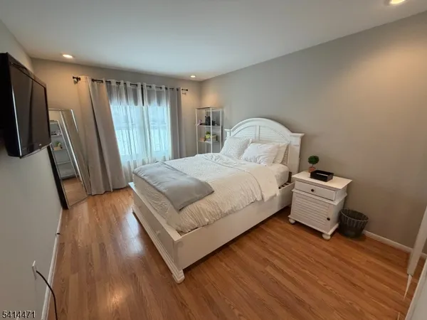 a spacious bedroom with a bed and a large window