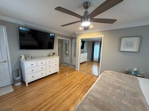 a bedroom with furniture and flat screen tv