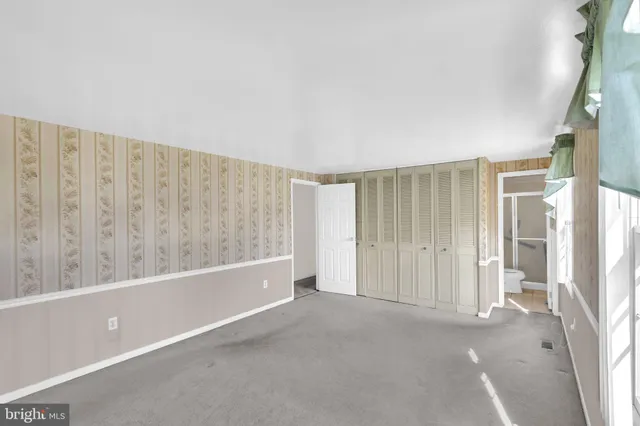 a view of an empty room with a fireplace