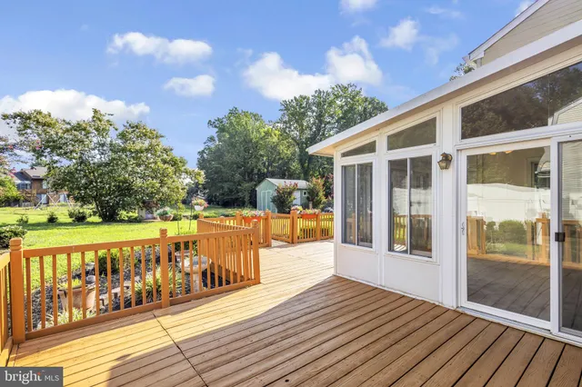 a view of a patio with table and chairs potted plants with wooden floor