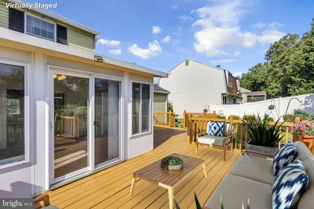 a view of a roof deck with wooden floor and fence