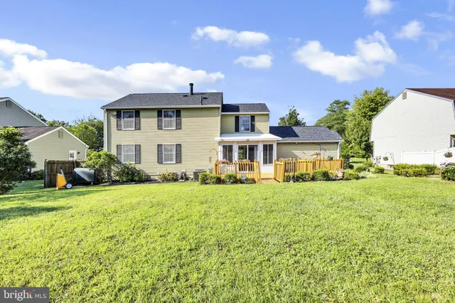 a front view of a house with yard and green space