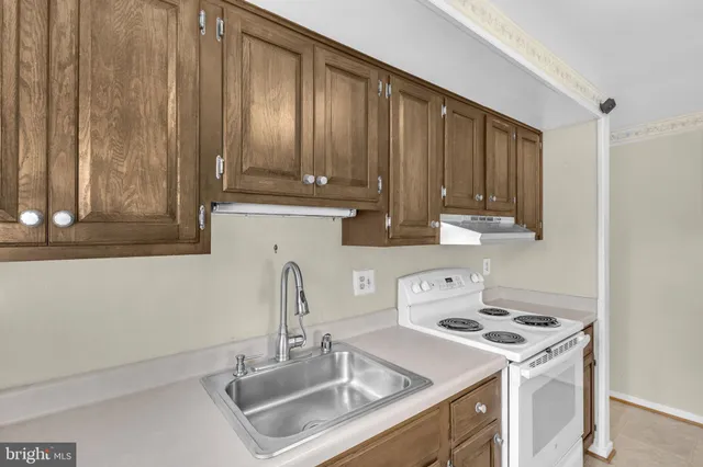 a kitchen with a sink a stove and a microwave