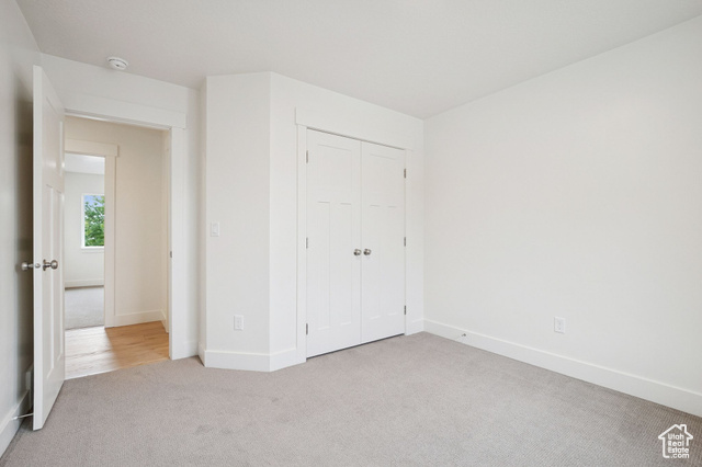 1615 North Angel Street, Unit H Layton, UT 84041 - Photo 25 of 55 Unfurnished bedroom with carpet flooring and a closet