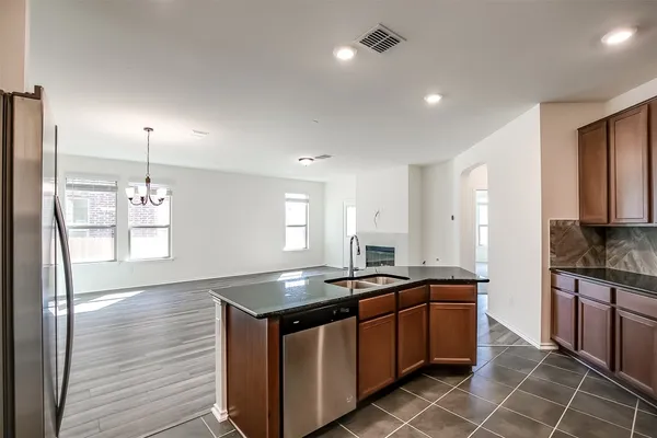 a kitchen with stainless steel appliances granite countertop a sink stove and cabinets