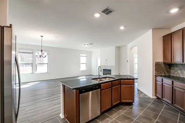 a kitchen with stainless steel appliances granite countertop a sink stove and cabinets