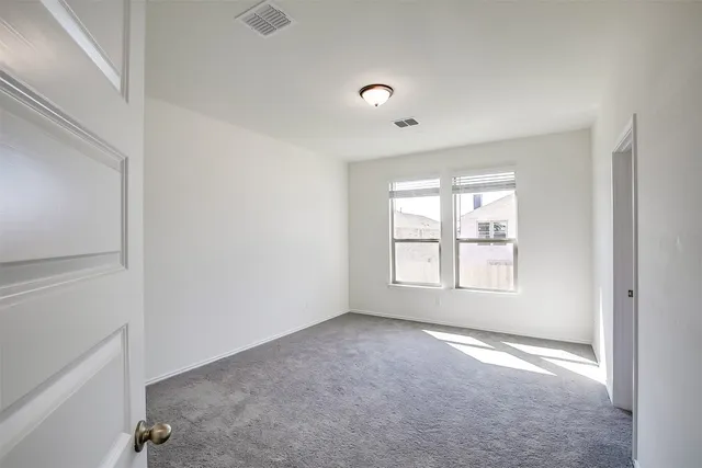 an empty room with a empty space and windows