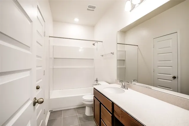 a bathroom with a sink toilet double vanity and tub
