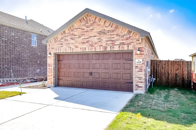 a view of a backyard with wooden fence