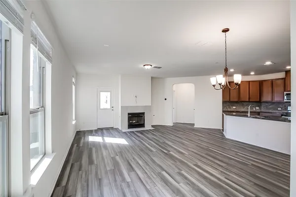 a view of a kitchen with a sink wooden floor and a large window