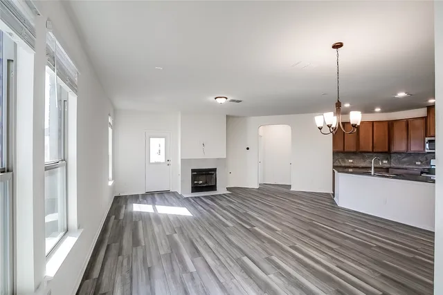 a view of a kitchen with a sink wooden floor and a large window