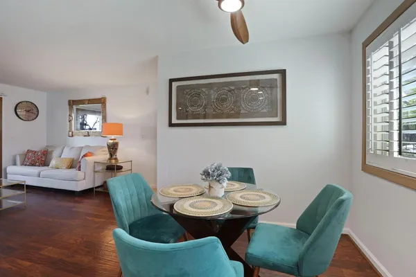 a view of a dining room with furniture and wooden floor