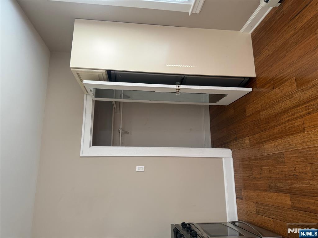 59 Union Avenue, Unit 3 North Arlington, NJ 07031 - Photo 2 of 15 an empty room with wooden floor and closet