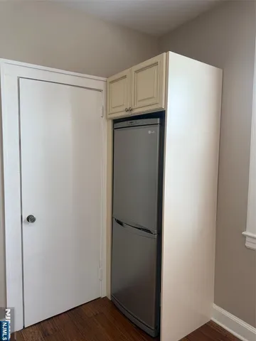 a view of walk in closet with wooden floor