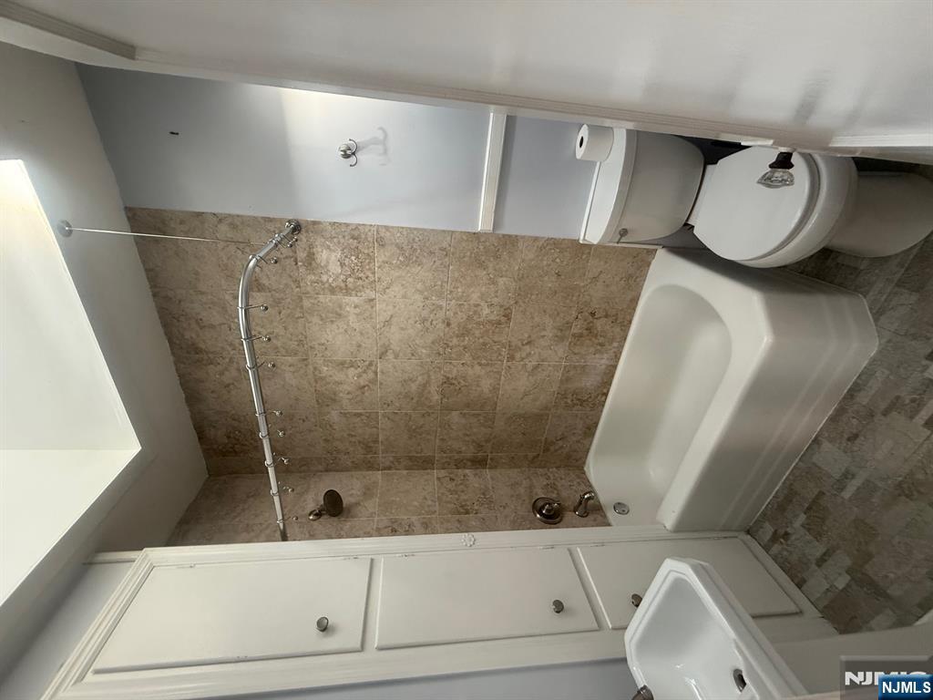 59 Union Avenue, Unit 3 North Arlington, NJ 07031 - Photo 7 of 15 a white toilet sitting next to a bath tub