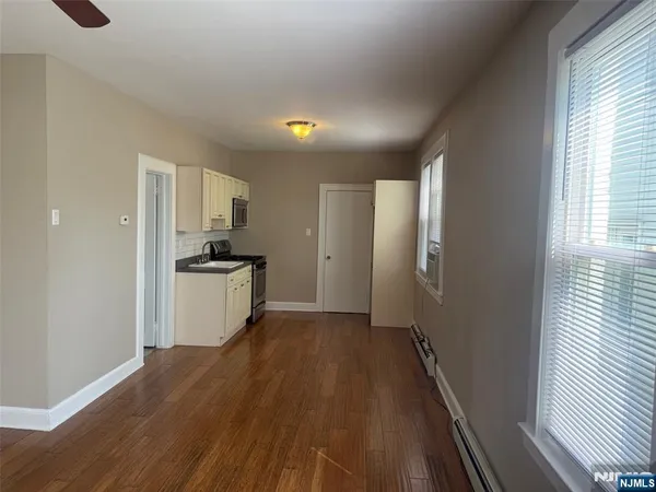a view of kitchen with wooden floor electronic appliances and window