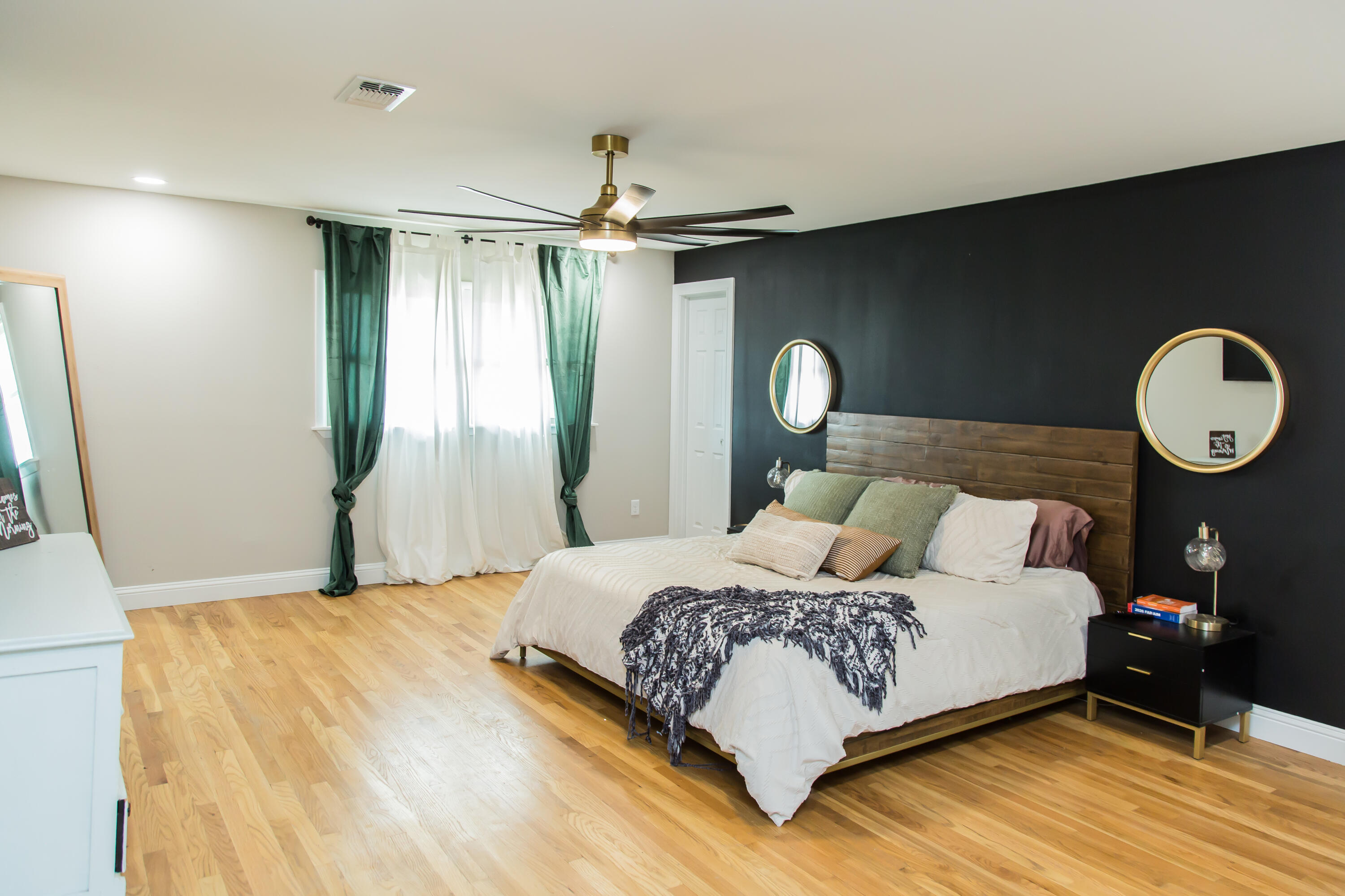 930 Sun Road Plainview, TX 79072 - Photo 11 of 22 a bedroom with a bed and a chandelier