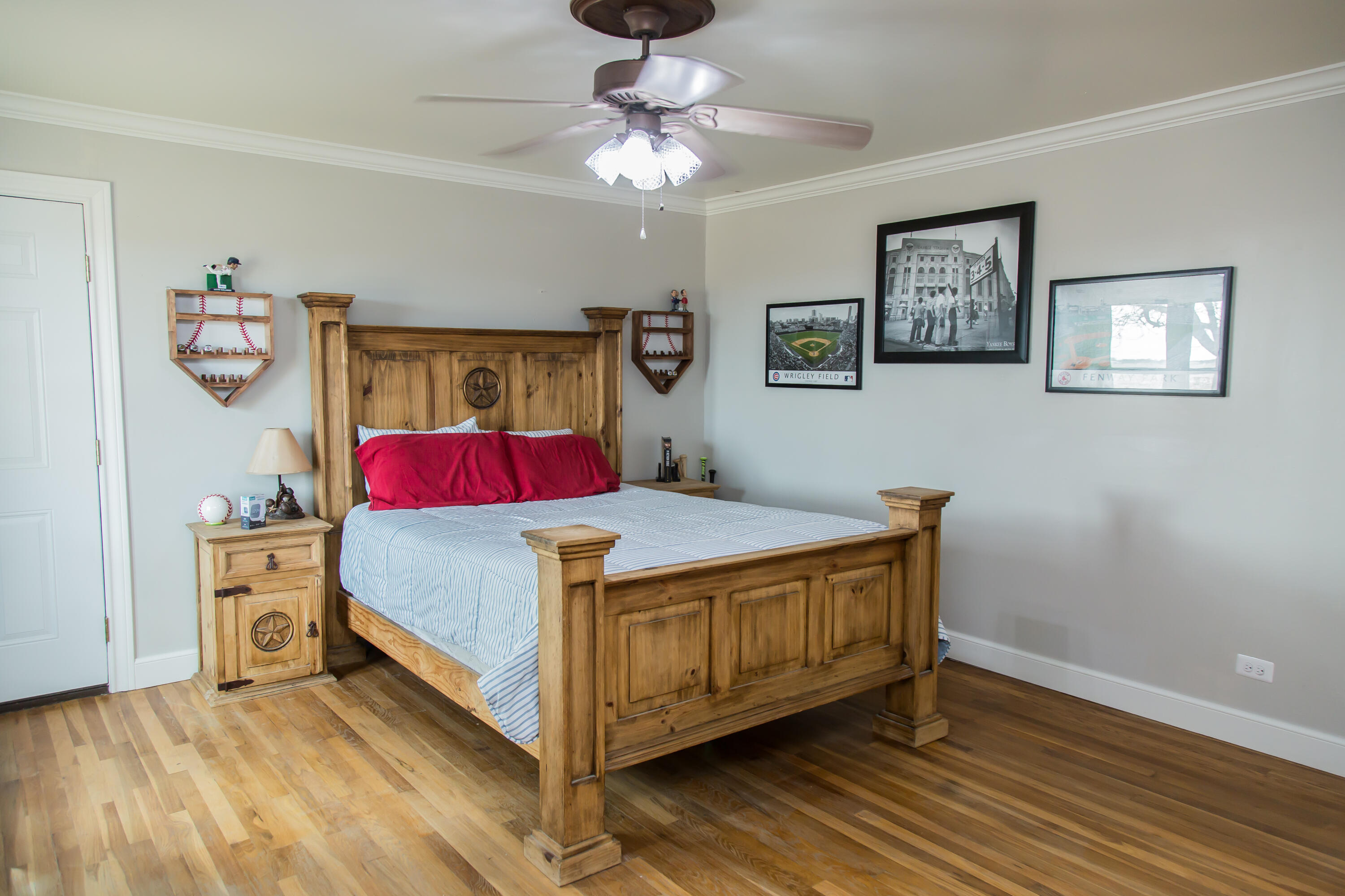 930 Sun Road Plainview, TX 79072 - Photo 16 of 22 a bedroom with a bed and a chandelier
