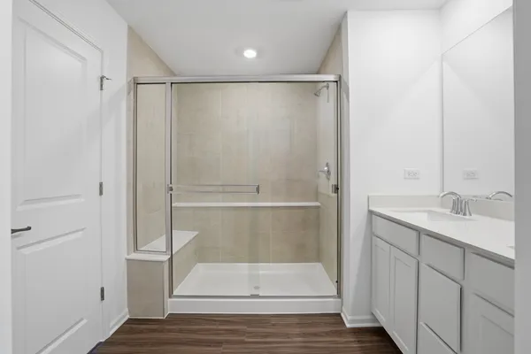 a bathroom with a sink a toilet and a large mirror