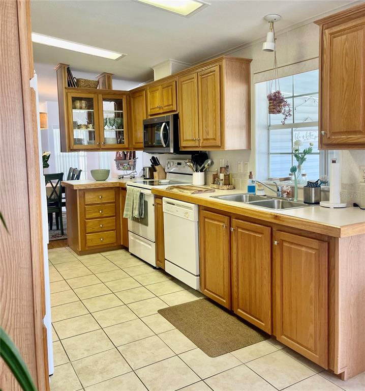 11200 Walsingham Road, Unit 139 Largo, FL 33778 - Photo 9 of 13 a kitchen with a sink stove and cabinets