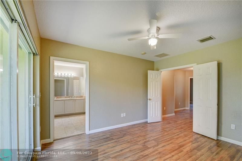4375 Emerald Vista Lake Worth Beach, FL 33461 - Photo 14 of 27 wooden floor in an empty room with a window
