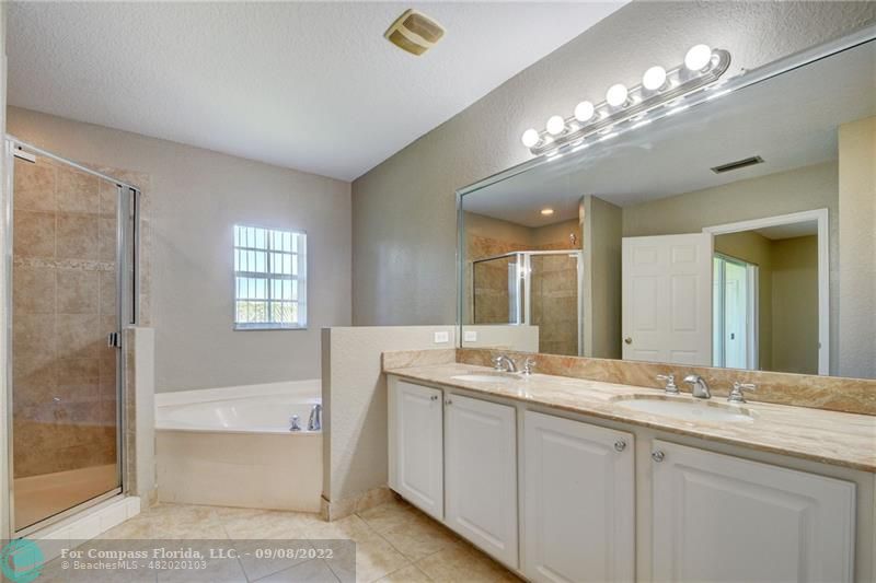 4375 Emerald Vista Lake Worth Beach, FL 33461 - Photo 17 of 27 a bathroom with a sink double vanity granite tub and a mirror