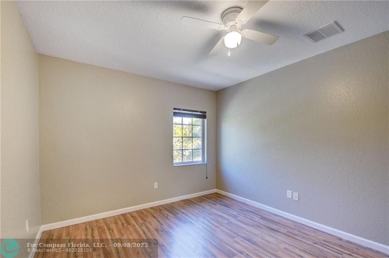 4375 Emerald Vista Lake Worth Beach, FL 33461 - Photo 21 of 27 wooden floor in an empty room with a window