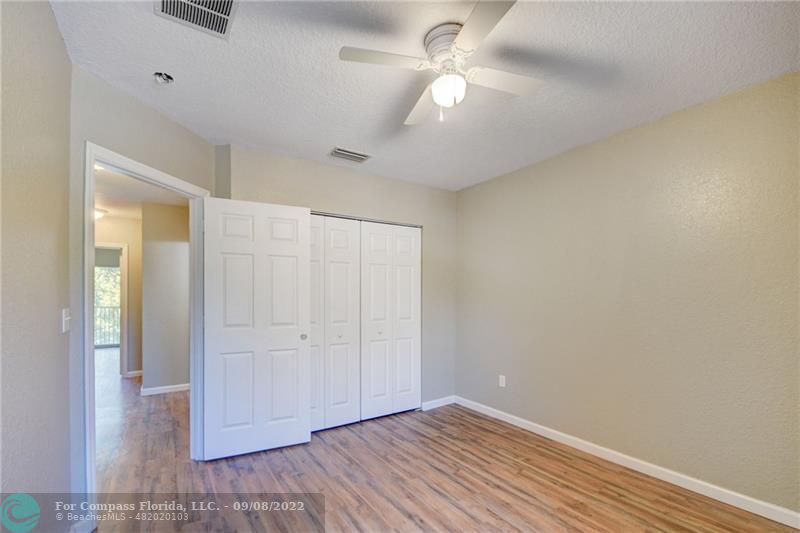 4375 Emerald Vista Lake Worth Beach, FL 33461 - Photo 22 of 27 an empty room with closet and a ceiling fan