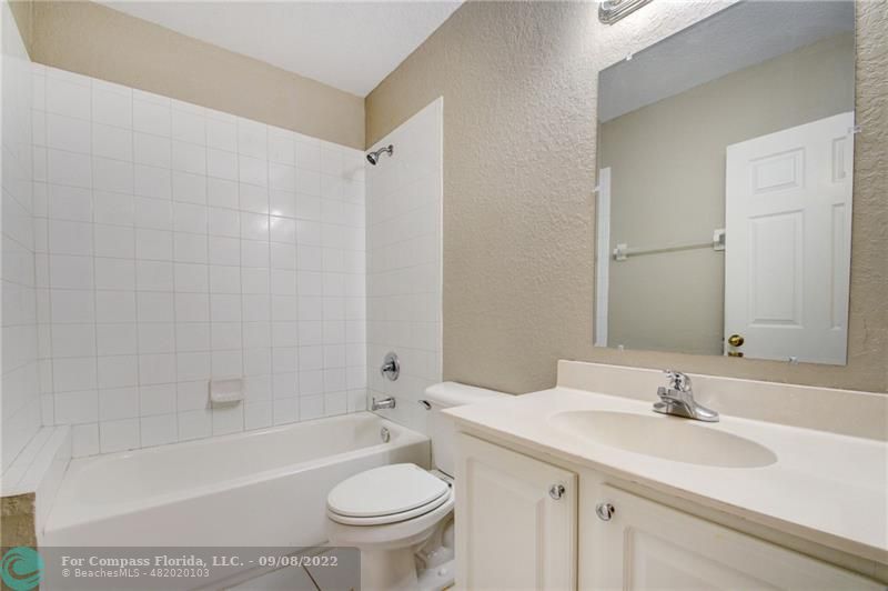 4375 Emerald Vista Lake Worth Beach, FL 33461 - Photo 23 of 27 a bathroom with a granite countertop sink toilet and shower