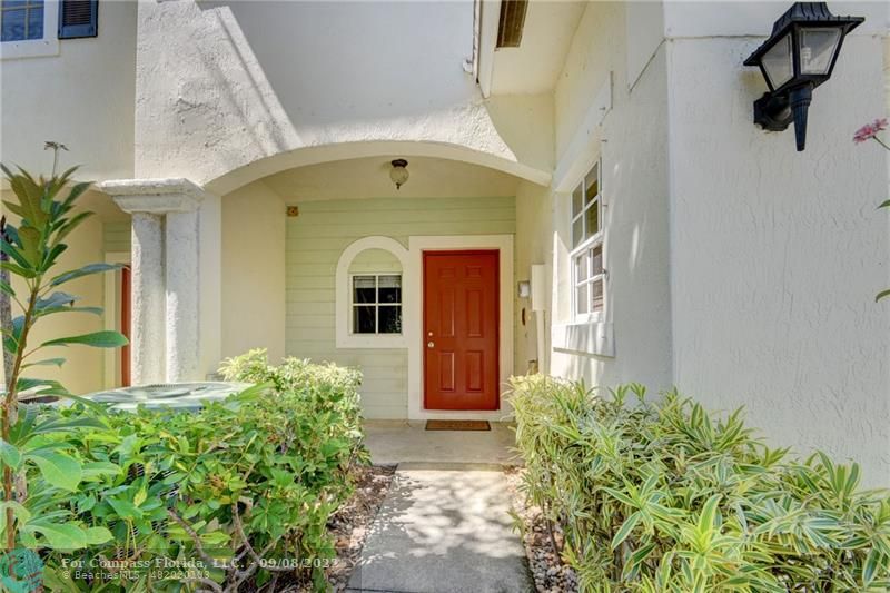 4375 Emerald Vista Lake Worth Beach, FL 33461 - Photo 3 of 27 a front view of a house with garden