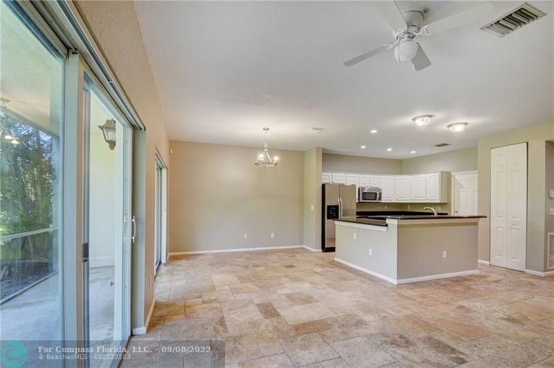 4375 Emerald Vista Lake Worth Beach, FL 33461 - Photo 10 of 27 a large kitchen with kitchen island a stove a refrigerator and a sink