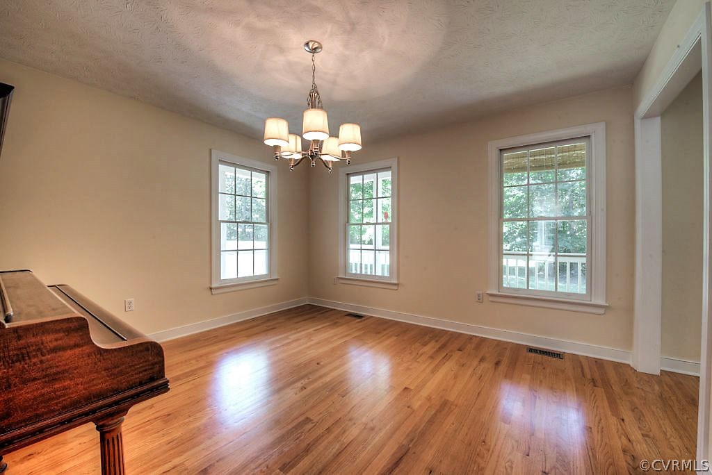 9217 Varina Road Henrico, VA 23231 - Photo 13 of 49 a view of an empty room with wooden floor and a window