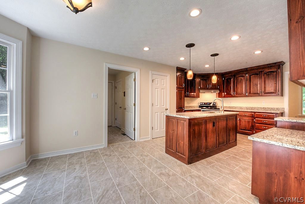9217 Varina Road Henrico, VA 23231 - Photo 17 of 49 a kitchen with stainless steel appliances kitchen island granite countertop a refrigerator and a stove top oven