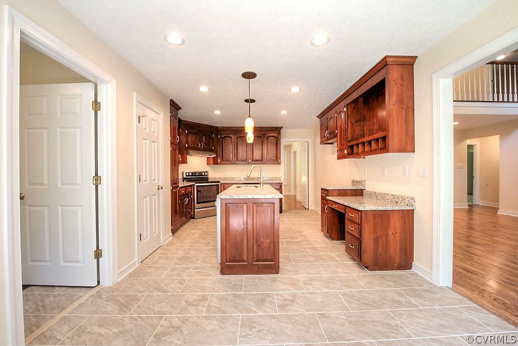 9217 Varina Road Henrico, VA 23231 - Photo 18 of 49 a kitchen with stainless steel appliances granite countertop a stove top oven a sink and a refrigerator