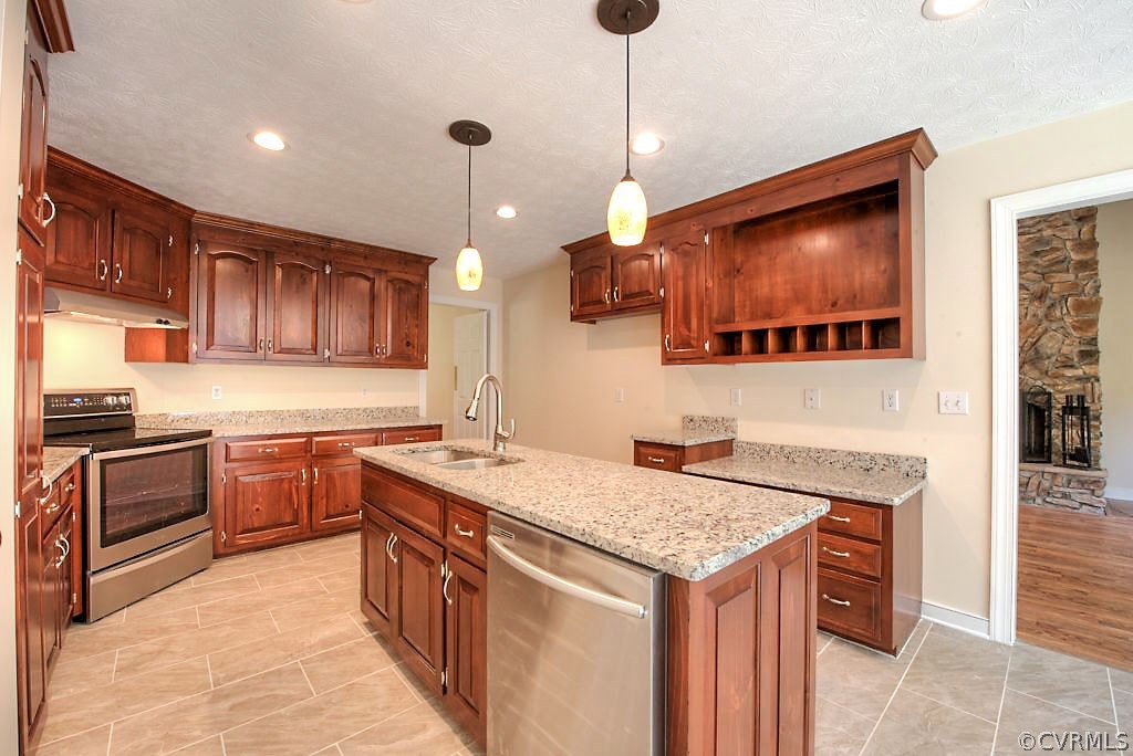 9217 Varina Road Henrico, VA 23231 - Photo 19 of 49 a kitchen with a stove sink and cabinets