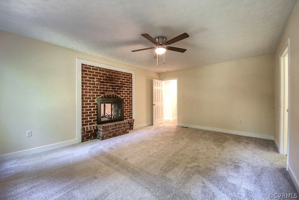 9217 Varina Road Henrico, VA 23231 - Photo 27 of 49 a view of an empty room with a fireplace and a window
