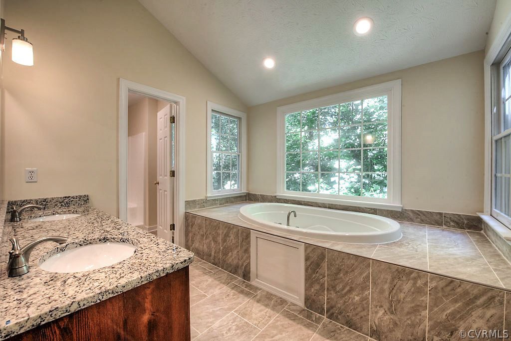 9217 Varina Road Henrico, VA 23231 - Photo 29 of 49 a spacious bathroom with a granite countertop tub sink and mirror