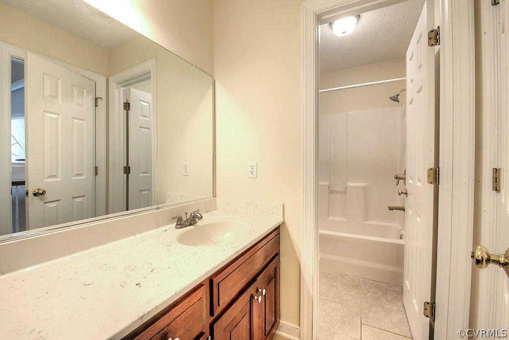 9217 Varina Road Henrico, VA 23231 - Photo 37 of 49 a bathroom with a granite countertop sink a mirror and a shower