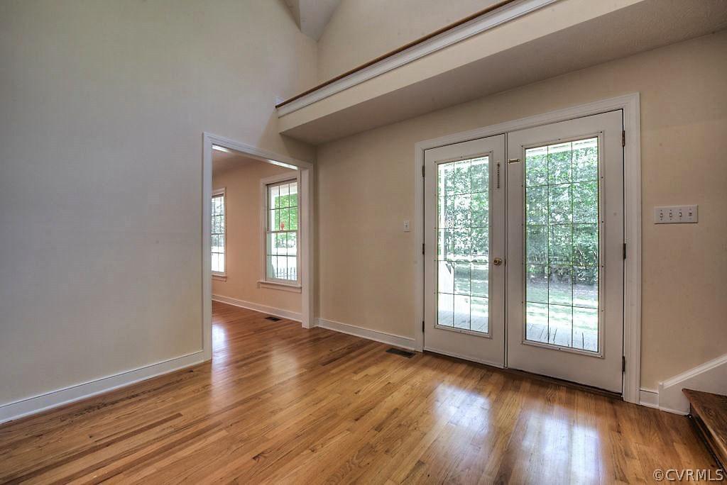 9217 Varina Road Henrico, VA 23231 - Photo 6 of 49 a view of an empty room with wooden floor and a window