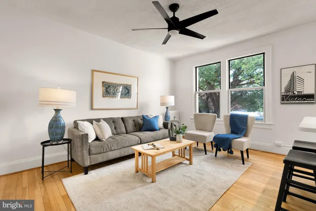 a living room with furniture and a large window